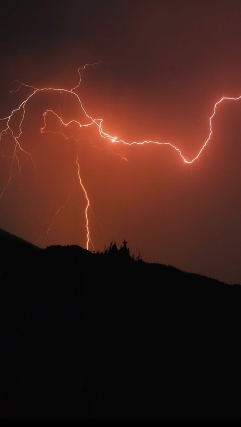 Red Lighting in Sky at Night