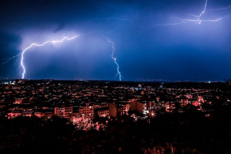 City With High Rise Buildings Under Blue Sky With Lightning