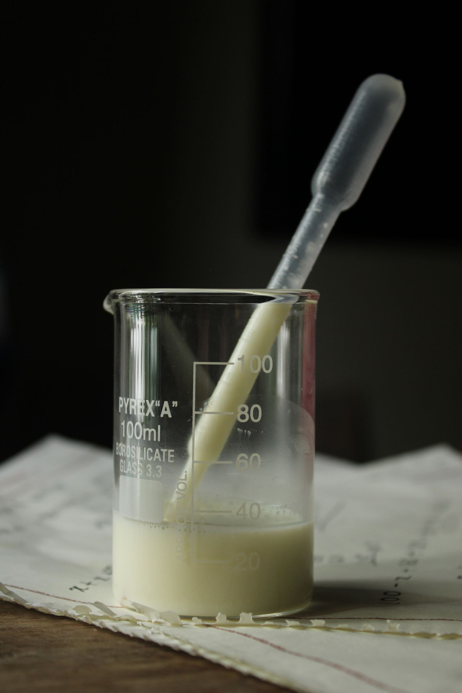Pyrex Beaker with White Liquid and Dropper
